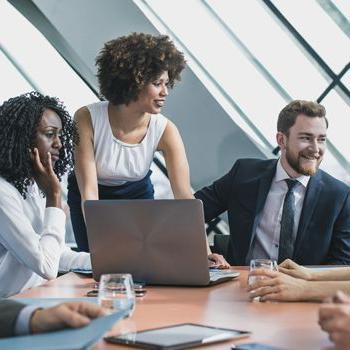 Patelco Home Loan Consultants seated around a conference table.