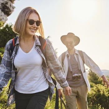 A young couple takes an afternoon hike.