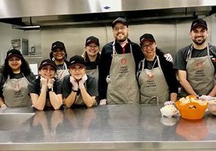 Patelco team members in the kitchen gettting ready to serve at Open Heart Kitchen